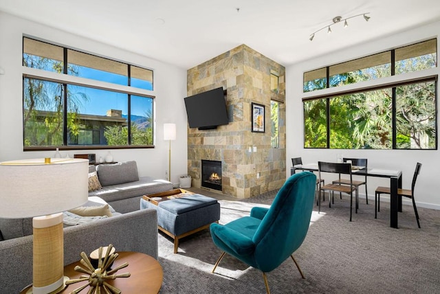 living room featuring carpet and a fireplace