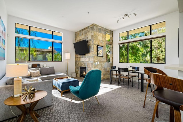 living room featuring carpet floors and a tiled fireplace