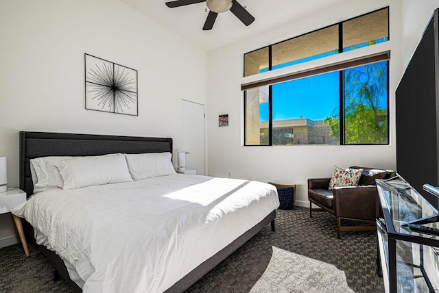 bedroom featuring ceiling fan and dark carpet