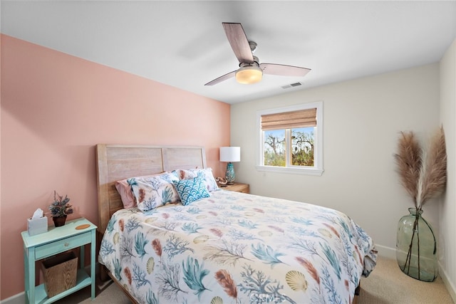 carpeted bedroom featuring visible vents, a ceiling fan, and baseboards