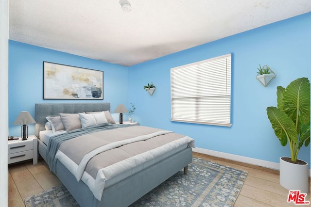 bedroom with light hardwood / wood-style flooring