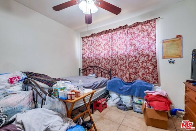 bedroom with ceiling fan and light tile patterned flooring