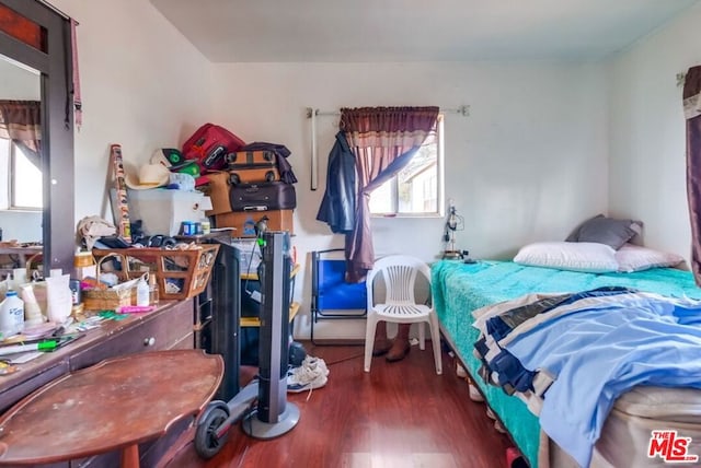 bedroom with dark wood-type flooring