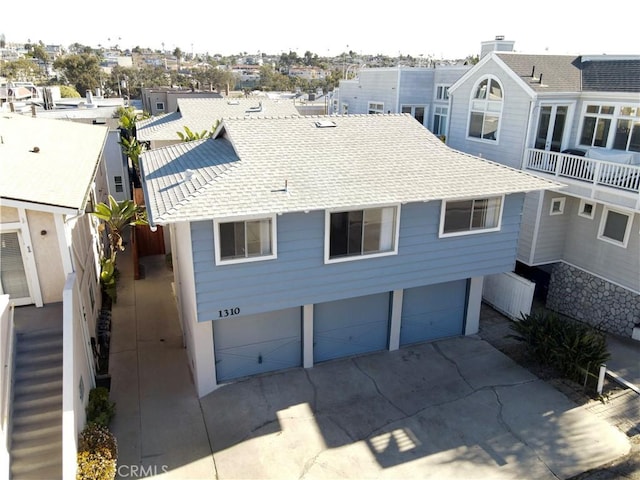 exterior space with roof with shingles