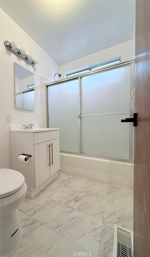 bathroom with visible vents, toilet, shower / bath combination with glass door, marble finish floor, and vanity