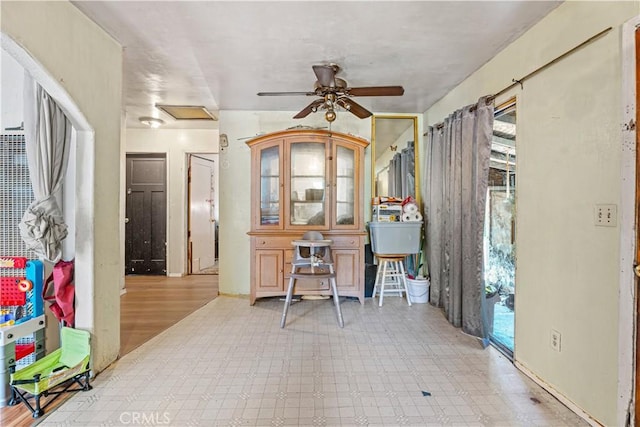 home office with ceiling fan and light hardwood / wood-style flooring