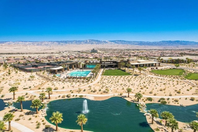 birds eye view of property with a water and mountain view