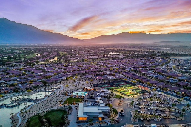 aerial view at dusk featuring a mountain view