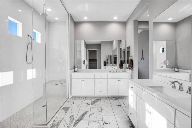 bathroom with vanity and tiled shower