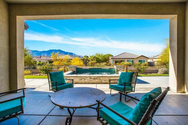 view of patio with a fenced in pool and a mountain view