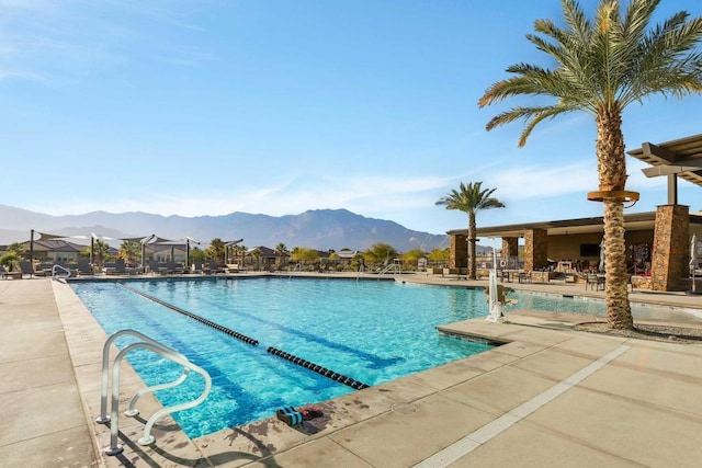 view of pool with a mountain view and a patio area