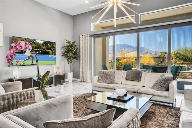 living room with a mountain view and an inviting chandelier