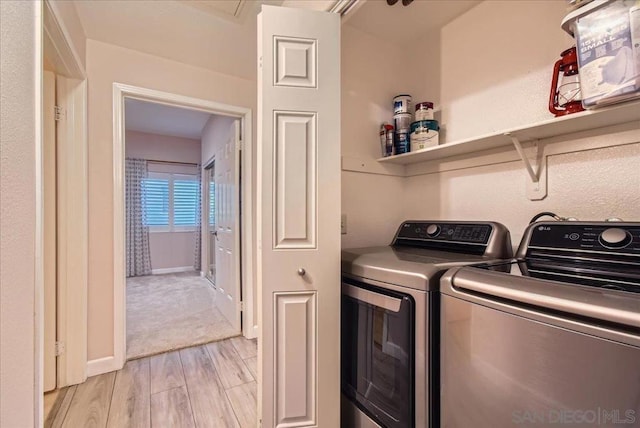 washroom featuring washer and dryer and light hardwood / wood-style floors