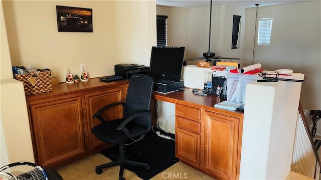 office featuring built in desk and light carpet