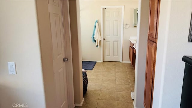 hall featuring light tile patterned flooring