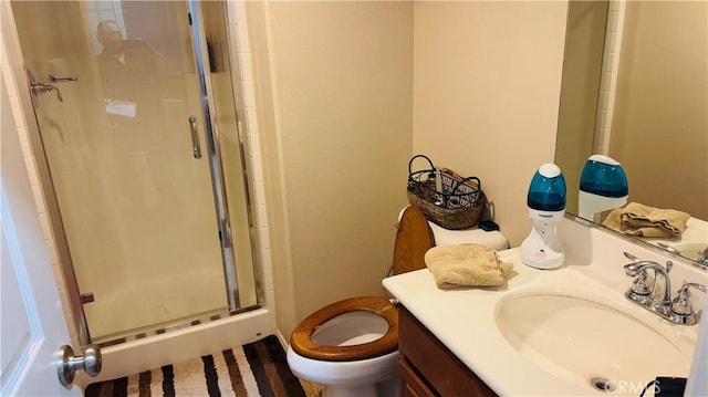 bathroom with vanity, toilet, and an enclosed shower