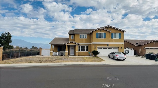 view of front of house with a mountain view, a porch, and a garage