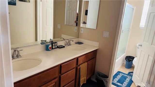 bathroom with combined bath / shower with glass door, vanity, a wealth of natural light, and tile patterned flooring