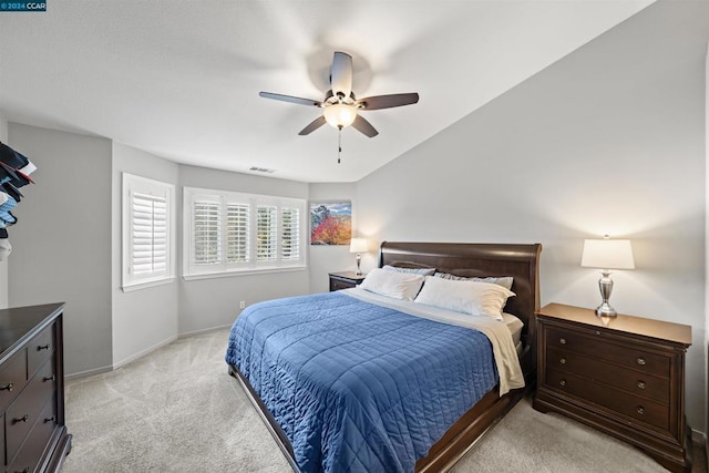 bedroom with ceiling fan and light colored carpet