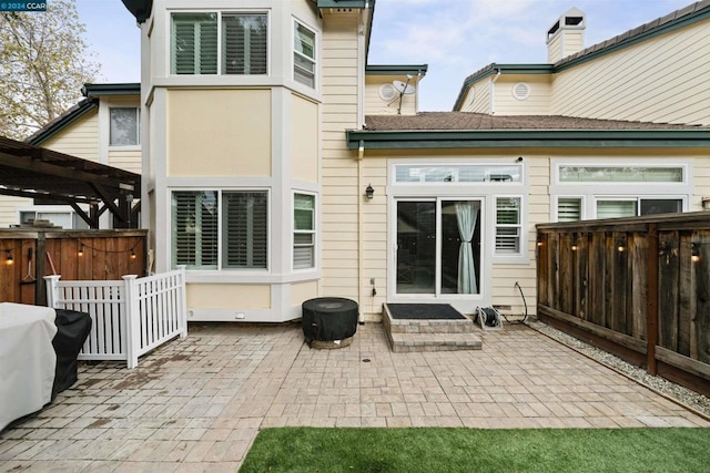 back of house with a pergola and a patio area