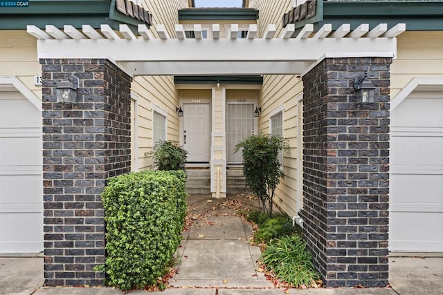 view of exterior entry featuring a garage