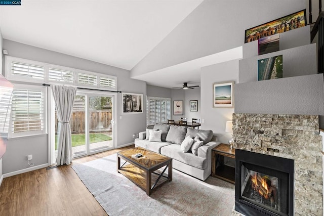 living room with high vaulted ceiling, ceiling fan, a fireplace, and hardwood / wood-style floors