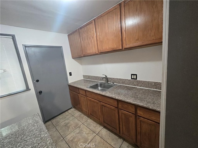 kitchen with sink and light tile patterned floors