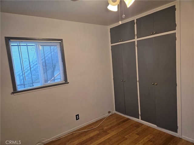 unfurnished bedroom featuring hardwood / wood-style flooring and a closet