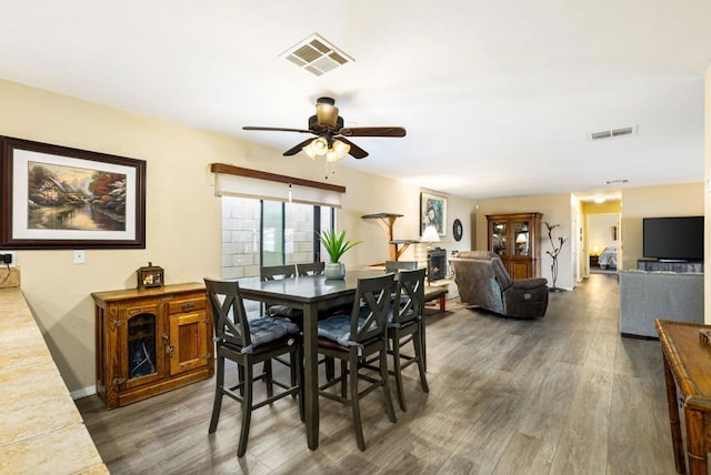 dining space featuring hardwood / wood-style floors and ceiling fan