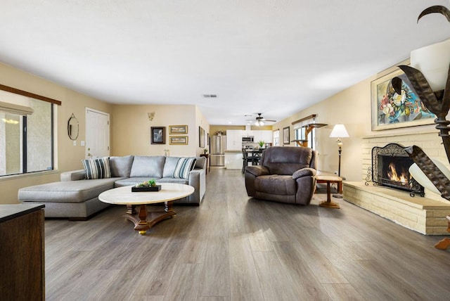 living room with ceiling fan and hardwood / wood-style flooring