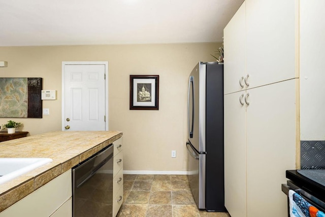 kitchen featuring dishwasher, white cabinetry, and stainless steel refrigerator