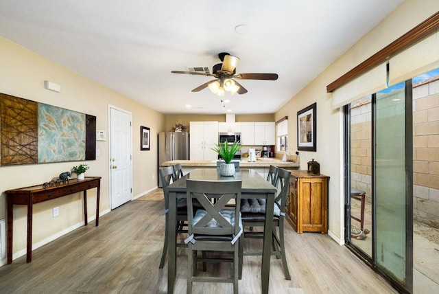 dining space featuring ceiling fan and light wood-type flooring