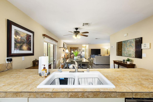 kitchen featuring ceiling fan and sink