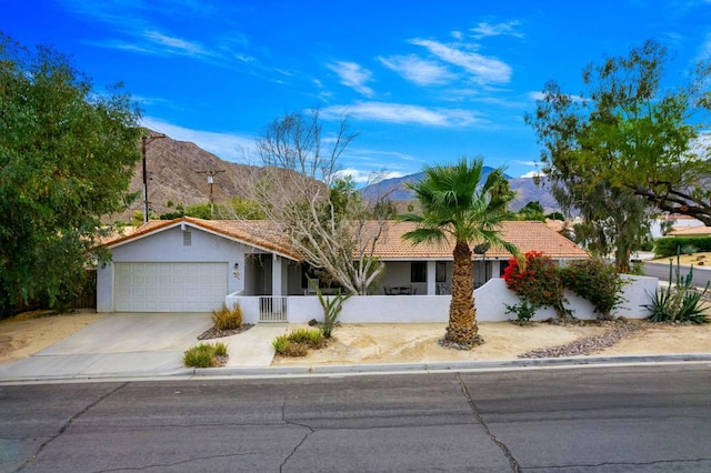 ranch-style home with a mountain view and a garage