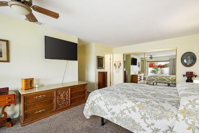 carpeted bedroom with ceiling fan and a closet