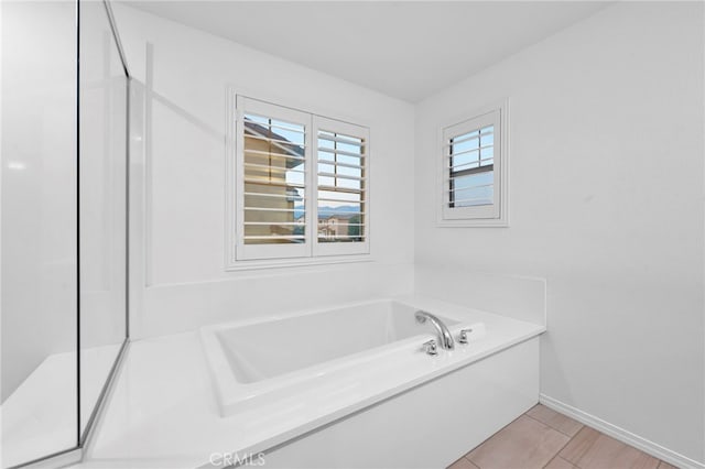 bathroom with tile patterned floors and a bathing tub