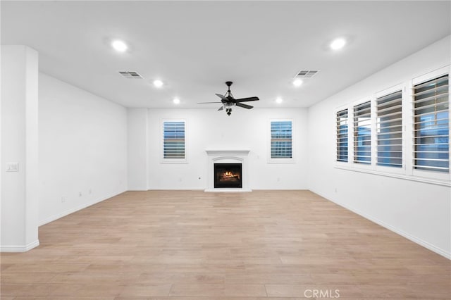 5418 Heitz Way, Fontana, CA 92336 - unfurnished living room with recessed lighting, ceiling fan, a lit fireplace, and light wood-style flooring