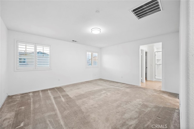 carpeted spare room featuring a wealth of natural light