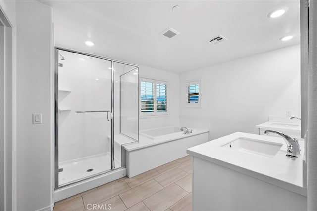 bathroom featuring separate shower and tub and vanity