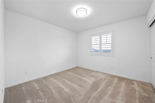 empty room featuring light colored carpet