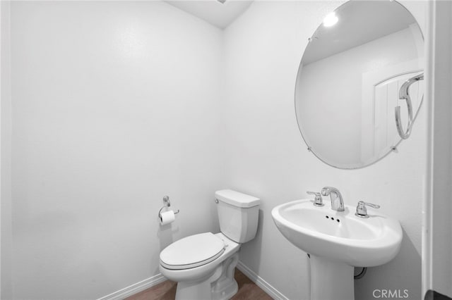 bathroom with wood-type flooring and toilet