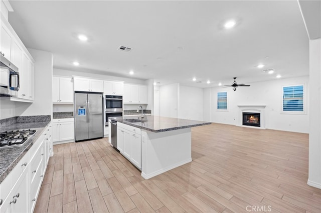 5418 Heitz Way, Fontana, CA 92336 - kitchen with stainless steel appliances, a ceiling fan, light wood-type flooring, recessed lighting, and white cabinetry