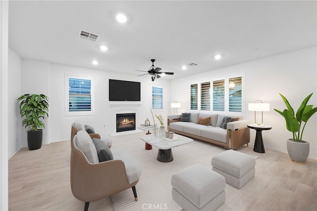 5418 Heitz Way, Fontana, CA 92336 - living area with light wood-type flooring, a ceiling fan, a warm lit fireplace, and recessed lighting