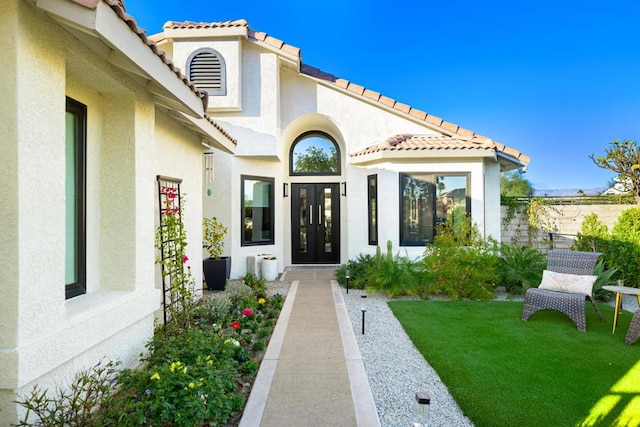 doorway to property featuring a yard