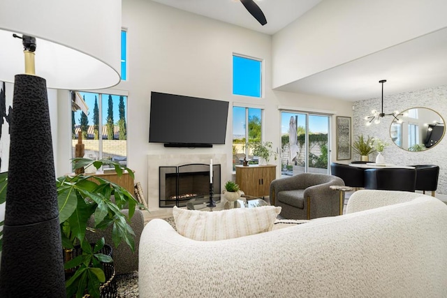 living room featuring ceiling fan with notable chandelier