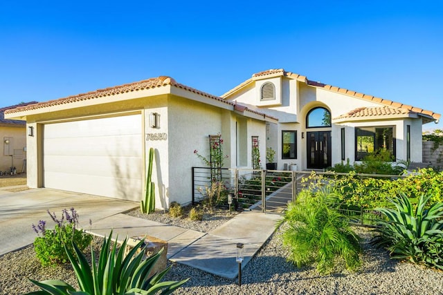 mediterranean / spanish-style home featuring a garage