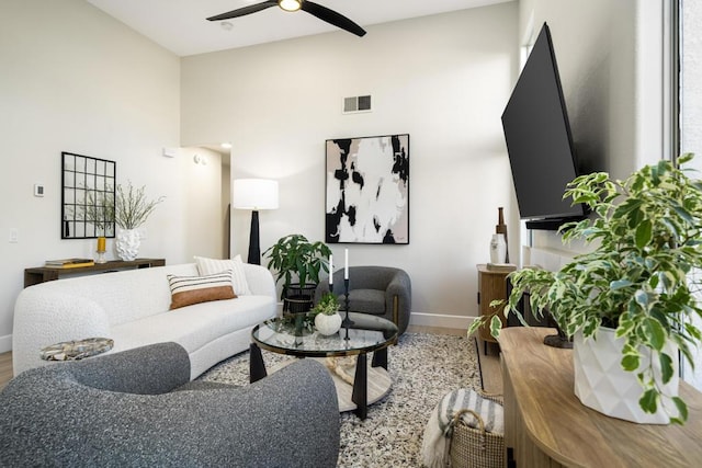 living room with ceiling fan and wood-type flooring