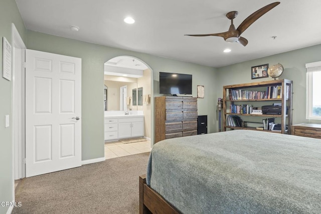 carpeted bedroom featuring ceiling fan and ensuite bathroom