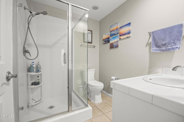 bathroom with toilet, an enclosed shower, tile patterned floors, and sink