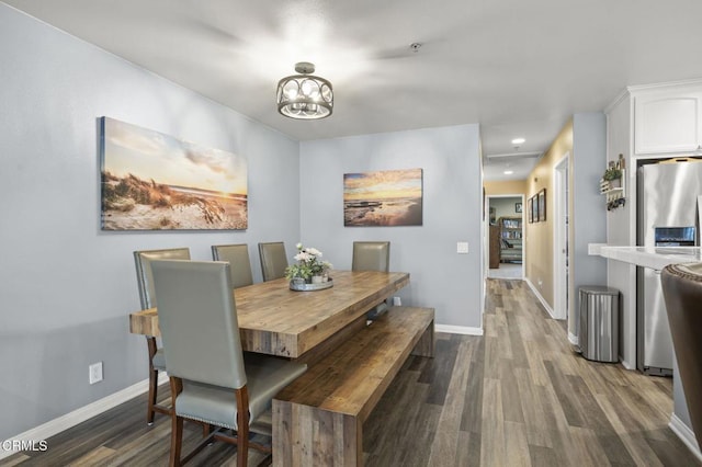 dining room with recessed lighting, dark wood-style floors, and baseboards